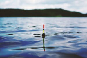 red yellow and black bouy on body of water during daytime